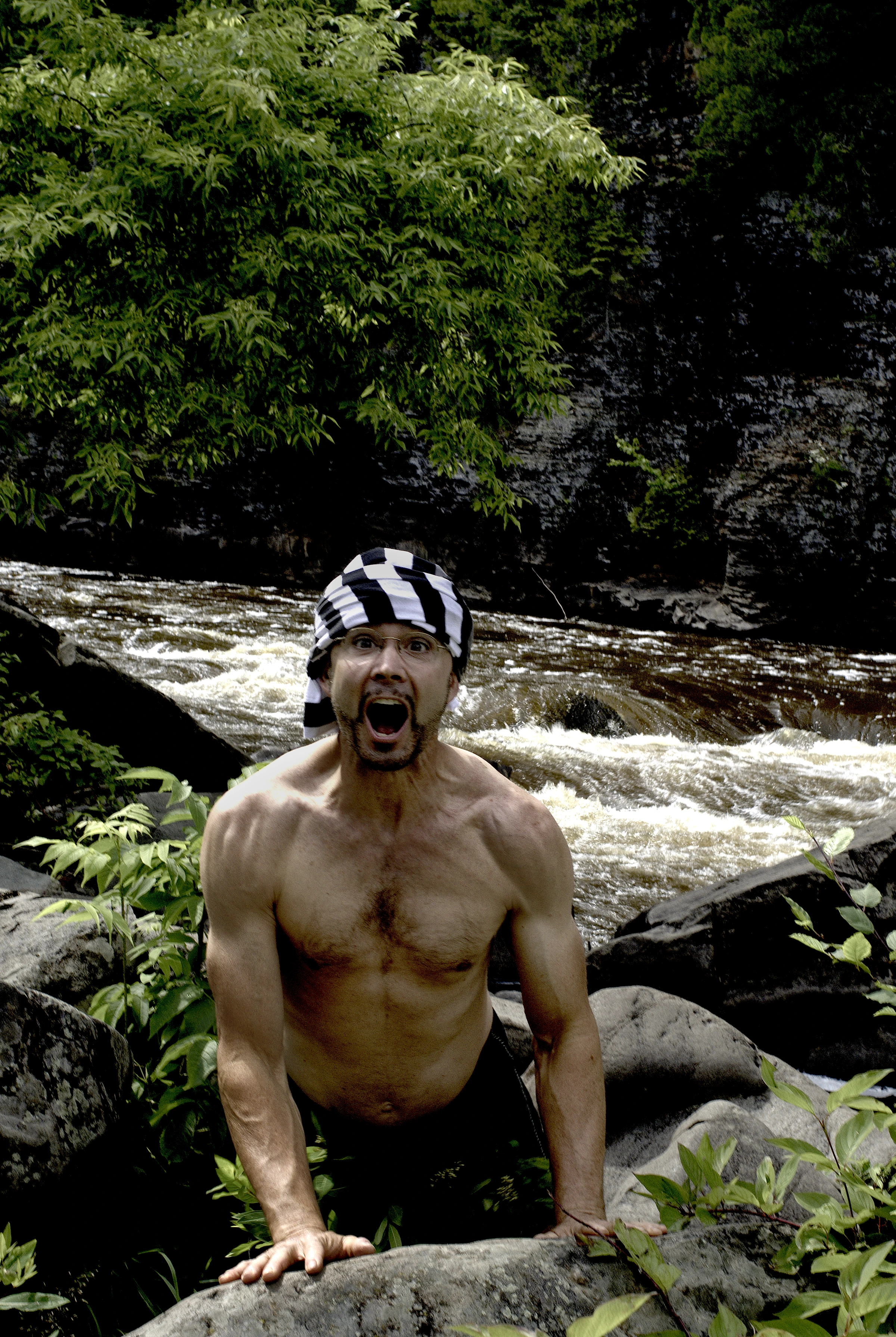 A figure calling out among river rocks, Northwoods